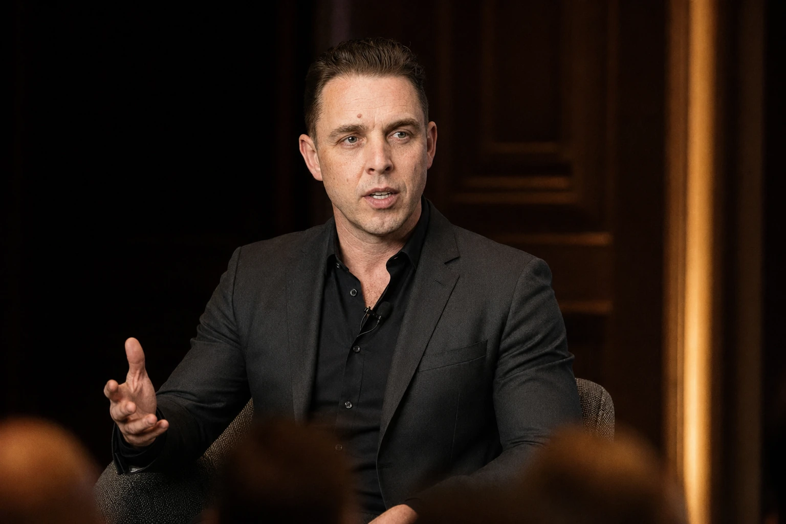 Audrius Cerkasovas speaking to an audience in a professional event setting.